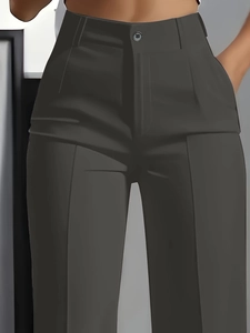 Detail of high waisted suit trousers with button closure and pressed creases