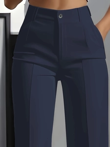 Detail of high waist navy dress pants featuring front pleats and button closure