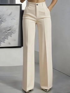 Detail of high-waist beige trousers with smooth drape fabric and front button closure