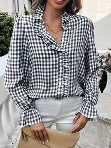 Detail of ruffle collar and gingham pattern on a long sleeve women's shirt