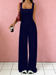Detail of navy blue square neck sleeveless jumpsuit with pleated waist and wide legs