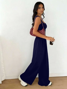 Detail of navy blue sleeveless vest and matching wide-leg pants set in solid color fabric
