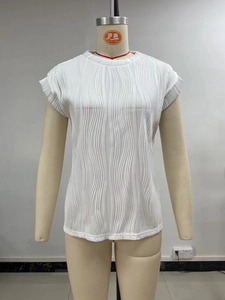 Close-up of white short sleeve top showing fine vertical pleated texture and crew neck