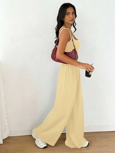 Detail view of bright yellow knit two-piece set featuring soft texture and drape