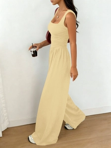 Detailed texture of beige sleeveless knit wide-leg jumpsuit with drawstring waist