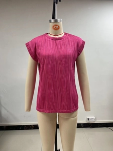 Detailed view of magenta pleated fabric texture on a short-sleeve round neck top