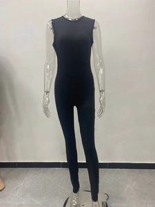 Detail view of a black sleeveless bodysuit jumpsuit with elastic fabric and crew neckline