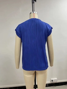 Close-up of royal blue pleated top featuring unique 3D wavy texture and round neckline
