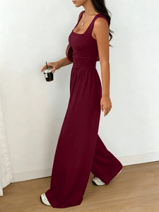 Detailed side view of dark wine red sleeveless top and wide-leg trousers set with waist folds