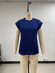 Detail of dark blue short-sleeve top showing the vertical wavy pleated texture fabric
