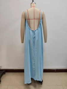 Detail view of the back of a light blue backless maxi dress with adjustable tie straps