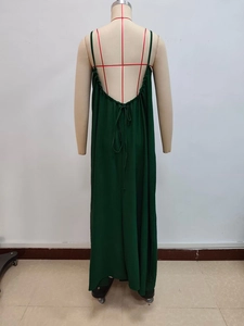 Back view of deep green backless maxi dress with thin straps and adjustable drawstring detail