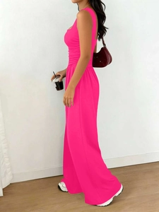 Detail view of high-waisted wide leg pants with pleated waist in hot pink stretch fabric