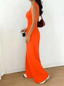 Detailed side view of high-waisted vibrant orange tank top and wide leg pants set