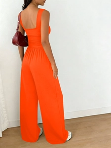 Detail of vibrant orange square neck tank top and high waist wide leg pants set