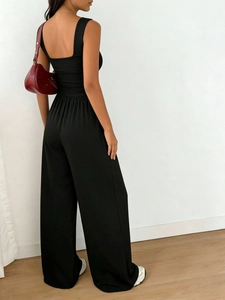 Detail showing back view of black slim-fit tank top and casual wide-leg pants set