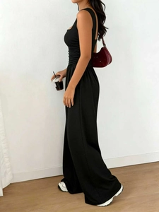 Detail view of the sleek black sleeveless top and high-waisted wide-leg pants set