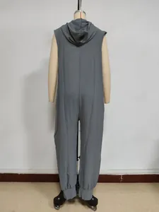 Detail of grey sleeveless hooded jumpsuit with button accents and textured fabric