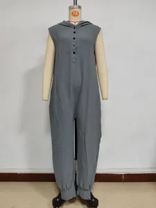 Detail view of grey sleeveless hooded jumpsuit featuring textured fabric and front buttons