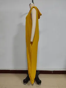 Detail view of yellow hooded sleeveless jumpsuit with side pockets and textured fabric