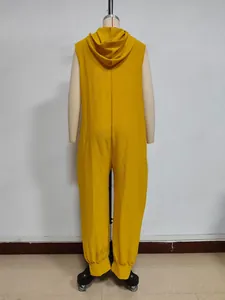 Detail of ginger yellow hooded sleeveless jumpsuit fabric and tapered ankle cuff