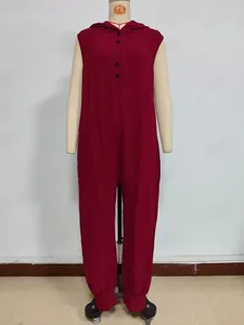 Detailed view of the dark red hooded sleeveless jumpsuit with black button closure design