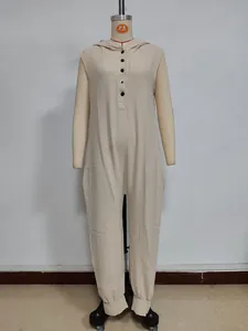 Detail view of beige sleeveless hooded jumpsuit with buttons and textured cotton fabric