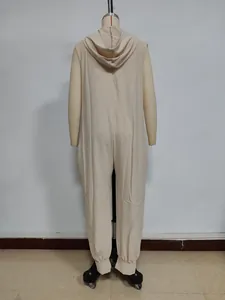 Detail of beige sleeveless hooded jumpsuit showing back hood and textured fabric