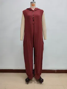 Detailed macro view of burgundy hooded jumpsuit showing cotton linen texture and front buttons
