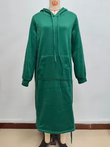 Detail of dark green oversized hoodie dress with large pocket and ribbed cuffs