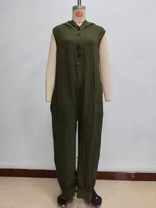 Detail of dark green sleeveless hooded jumpsuit featuring textured fabric and front buttons