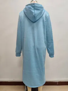 Detail of light blue oversized hoodie featuring a curved hem and thick cotton blend fabric