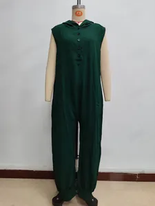 Detail of dark green sleeveless hooded jumpsuit featuring button closure and textured fabric