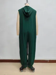 Detail of dark green hooded sleeveless jumpsuit with textured fabric and drop crotch
