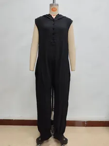 Detail view of the button closure and textured fabric on this black sleeveless hooded romper