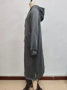Detail view of dark grey long hoodie featuring side slits and large front pockets