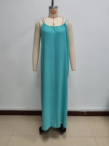 Detail of teal sleeveless maxi dress with thin straps and pleated neckline detail