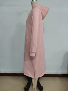 Detailed side view of pink oversized hoodie dress with side slits and decorative drawstrings