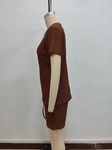 Detail of dark brown pleated fabric texture on a casual short sleeve two-piece set