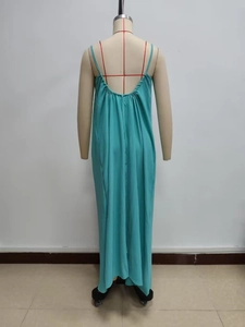 Detail of teal backless maxi dress featuring thin straps and pleated back tailoring