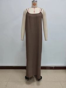 Detail of a long brown camisole dress featuring thin straps and a flowy straight silhouette