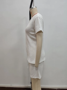 Detail shot of white short sleeve two-piece set with vertical pleated texture fabric
