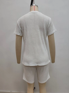 Detail view of the back of a white short sleeve T-shirt and shorts set with rib knit texture