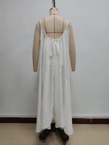 Detail of white spaghetti strap dress showing U-neckline and back lace-up design