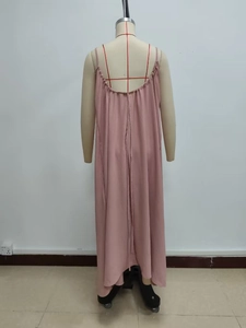 Detail of dusty pink spaghetti strap dress with ruffled back and pleated fabric texture