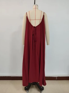 Detail of burgundy backless strap dress showing delicate tie-up design and fabric texture
