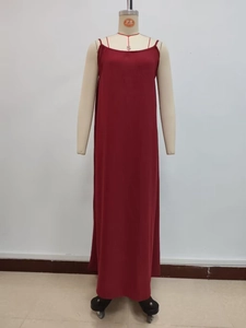 Detail of dark red pleated fabric texture on a long strap dress with loose fit