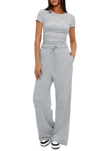 Detail of grey short sleeve top with side pleats and high waist drawstring trousers