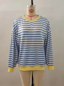 Detail of blue and white striped long sleeve top with contrasting yellow ribbed cuffs