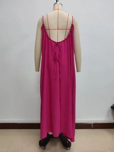 Back view of loose rose red backless maxi dress with thin straps and tie detailing
